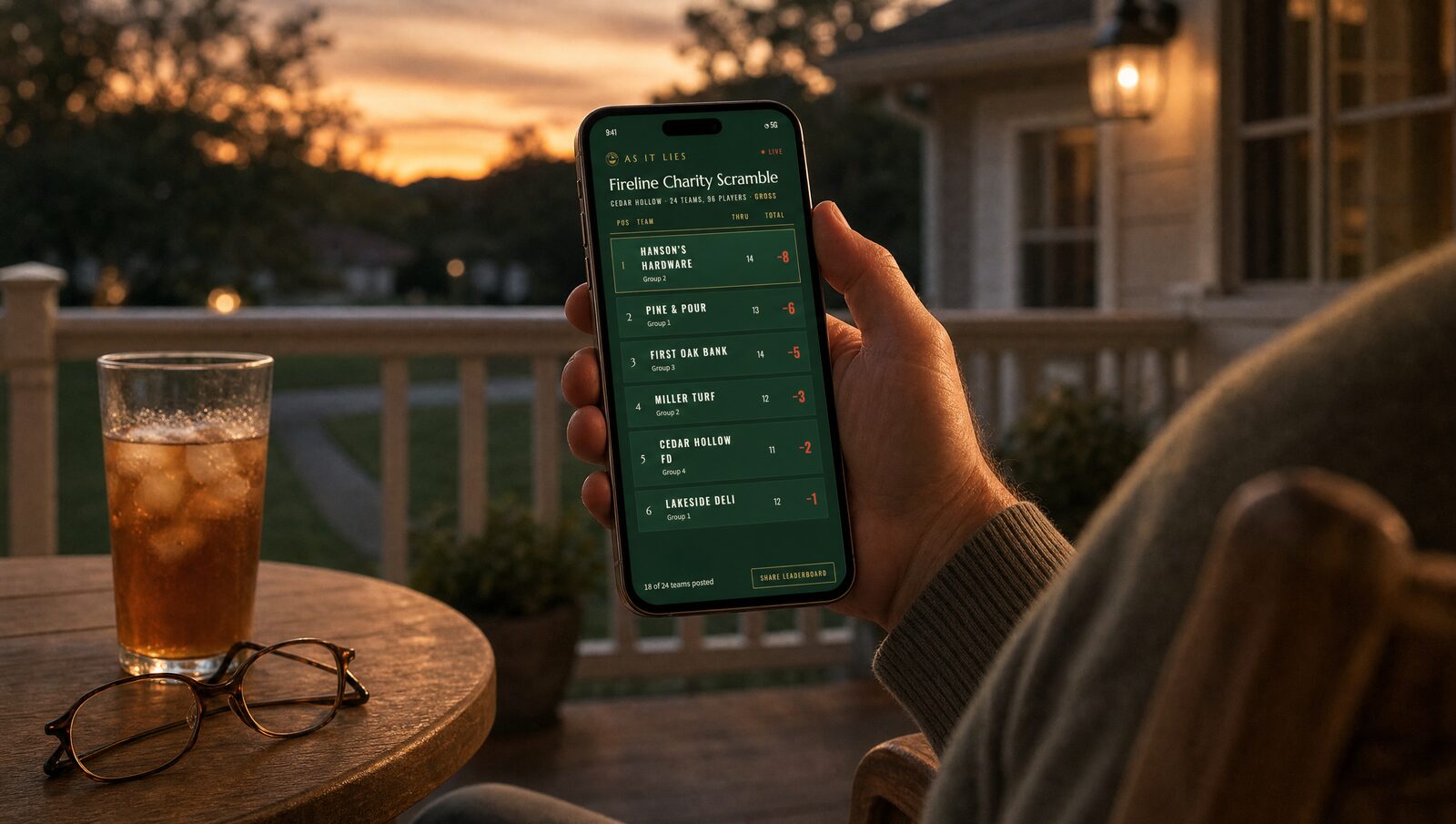 Following the live leaderboard from a porch at home on a phone at dusk