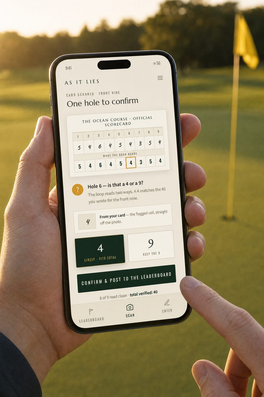 Hands holding a phone at the green, confirming an ambiguous digit with one tap